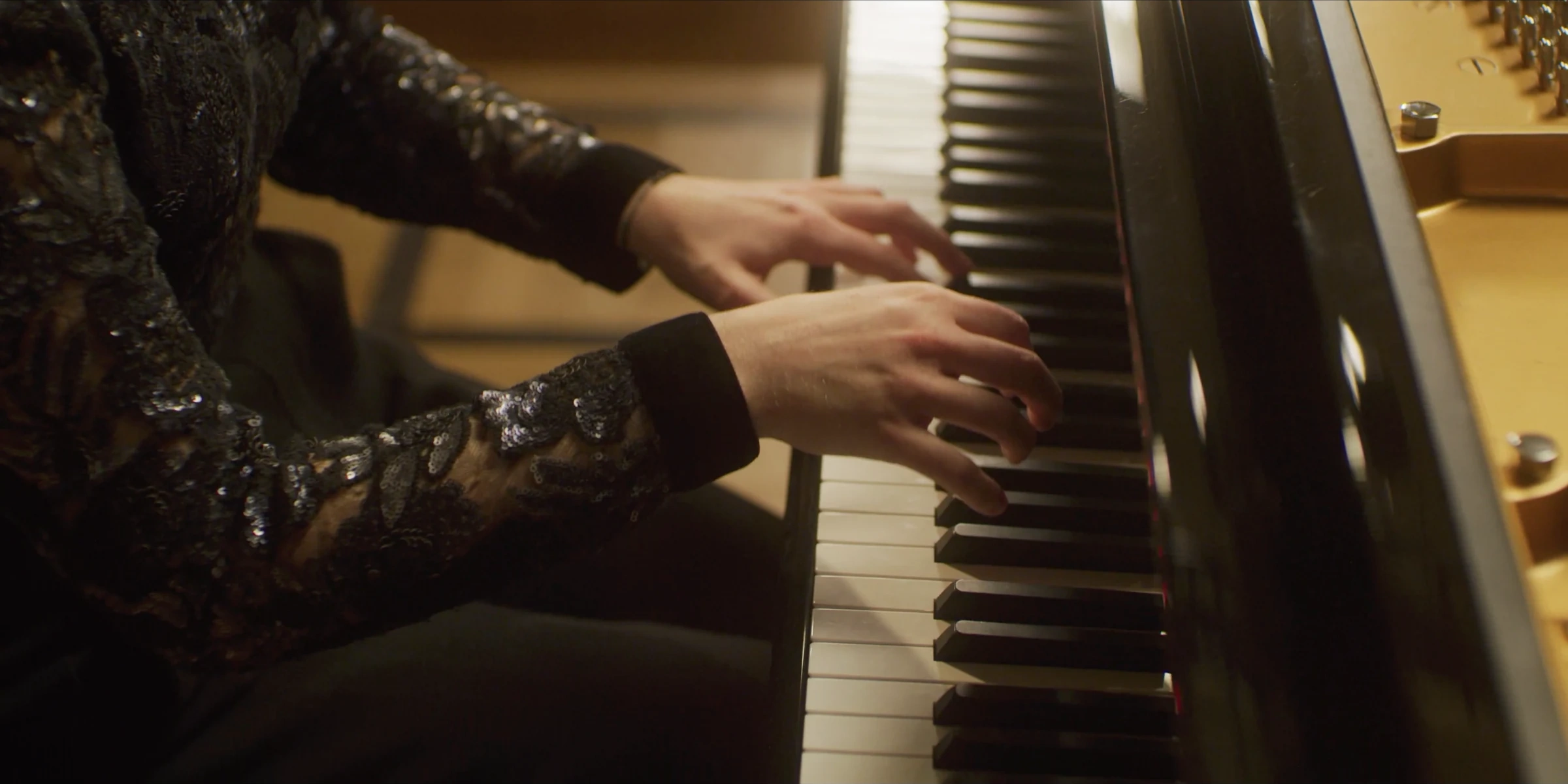 Hands playing the piano