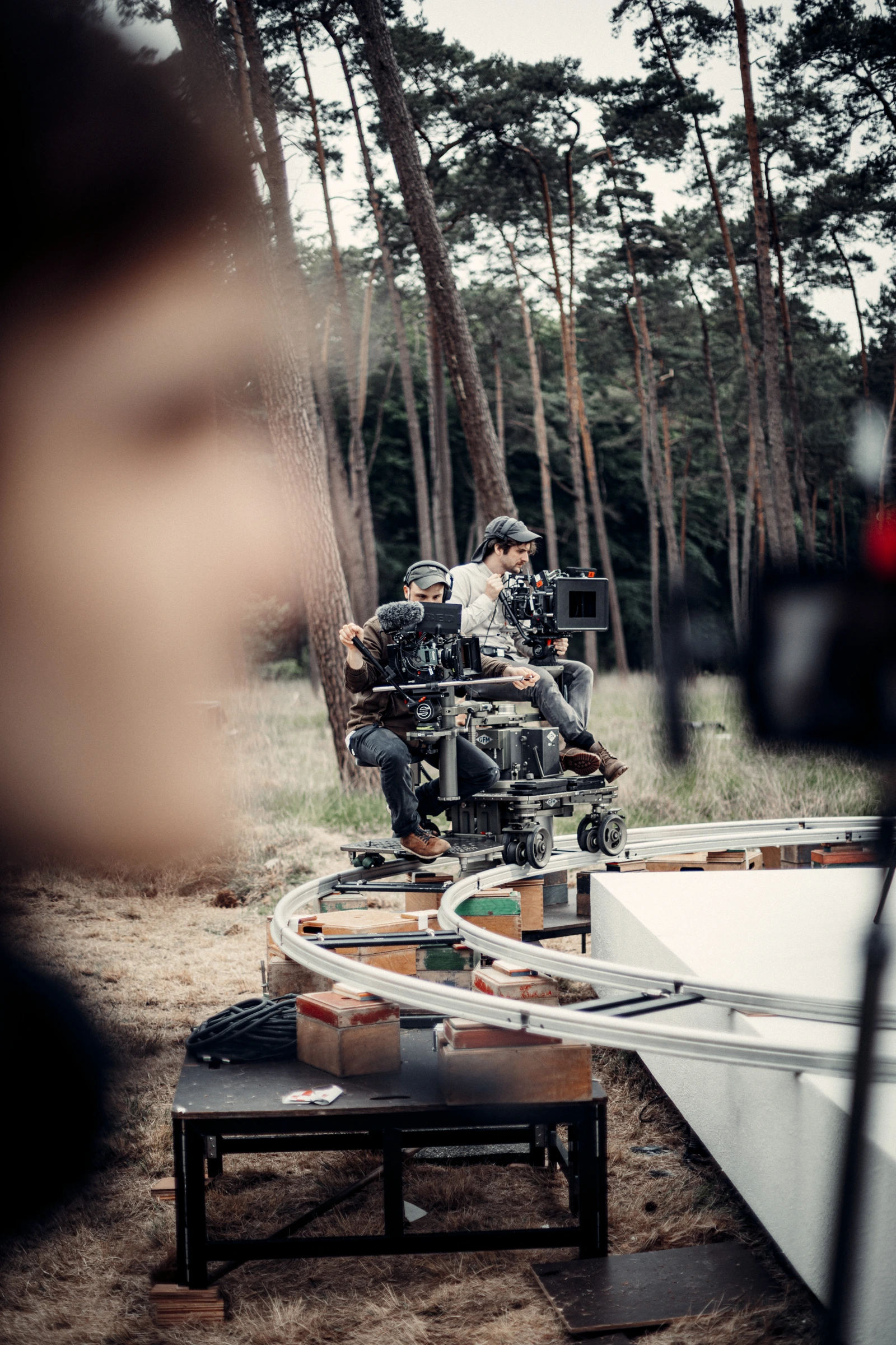 Camera crew working on curved dolly tracks