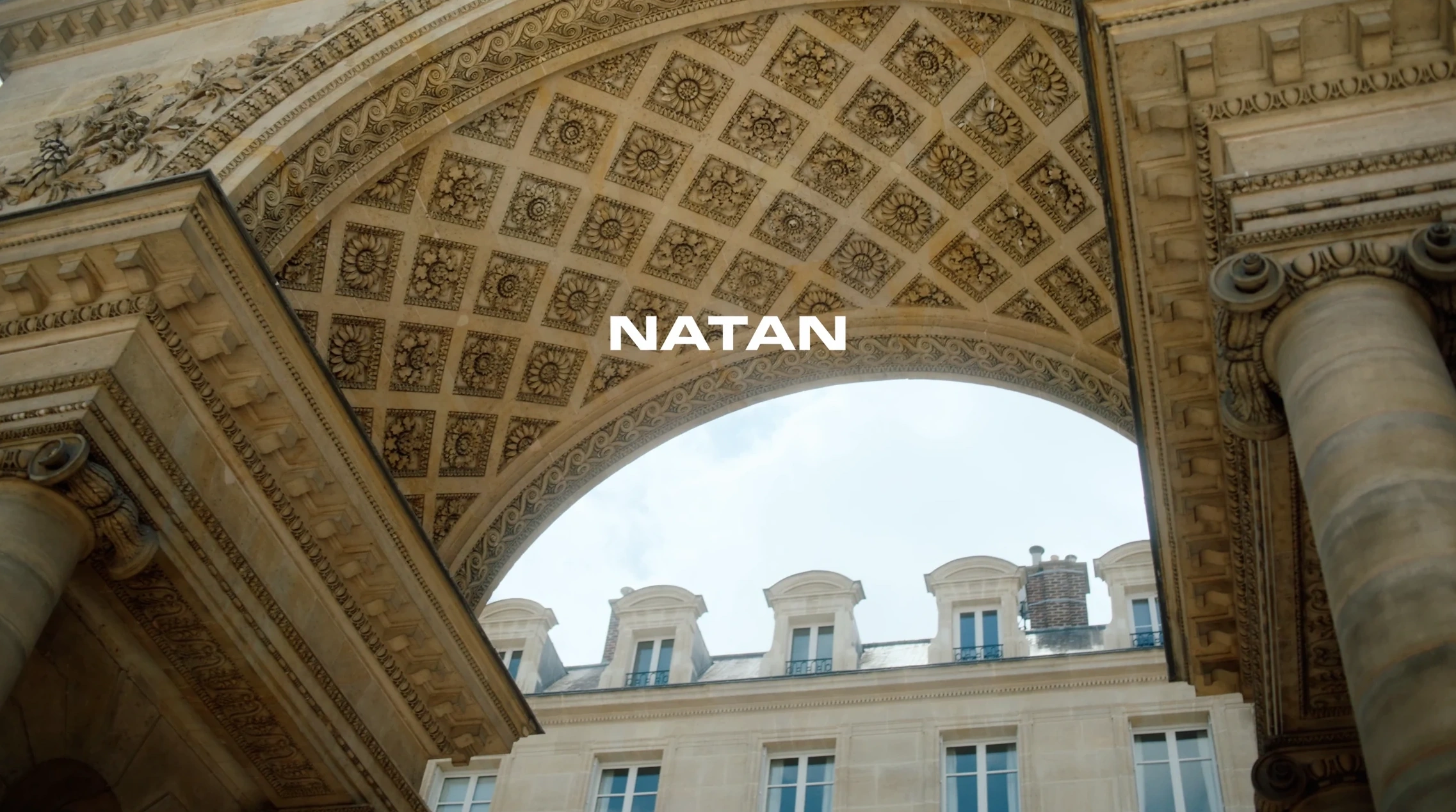 Natan title beneath a carved stone arch