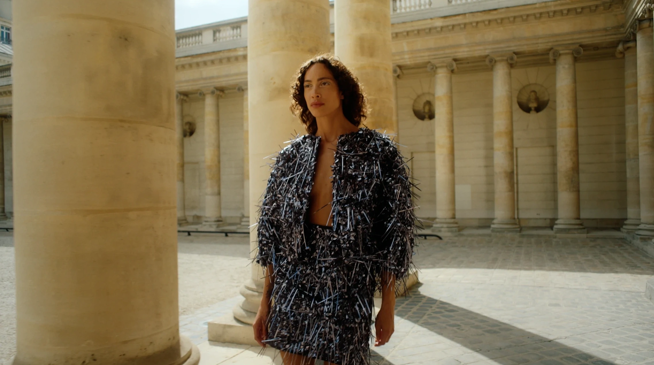 Textured couture jacket among the columns