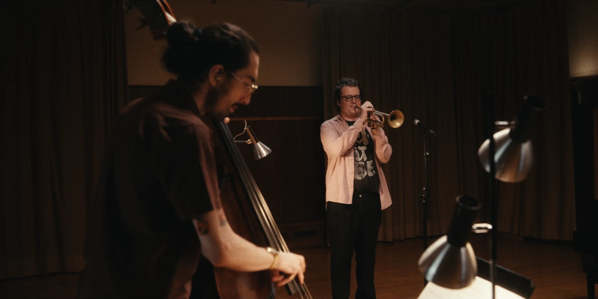Double bassist with the trumpeter in the background