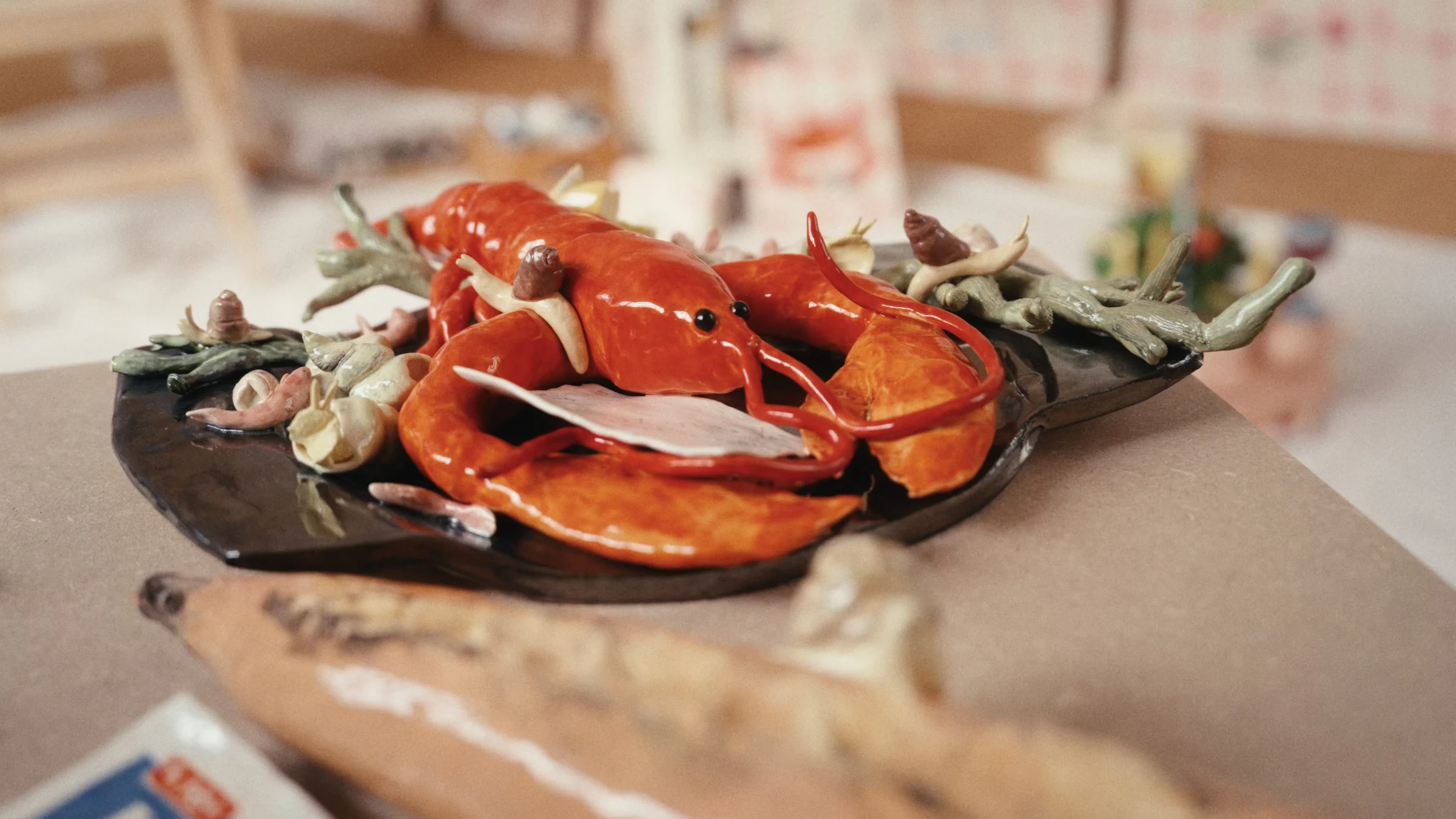 Ceramic lobster surrounded by small sculptures