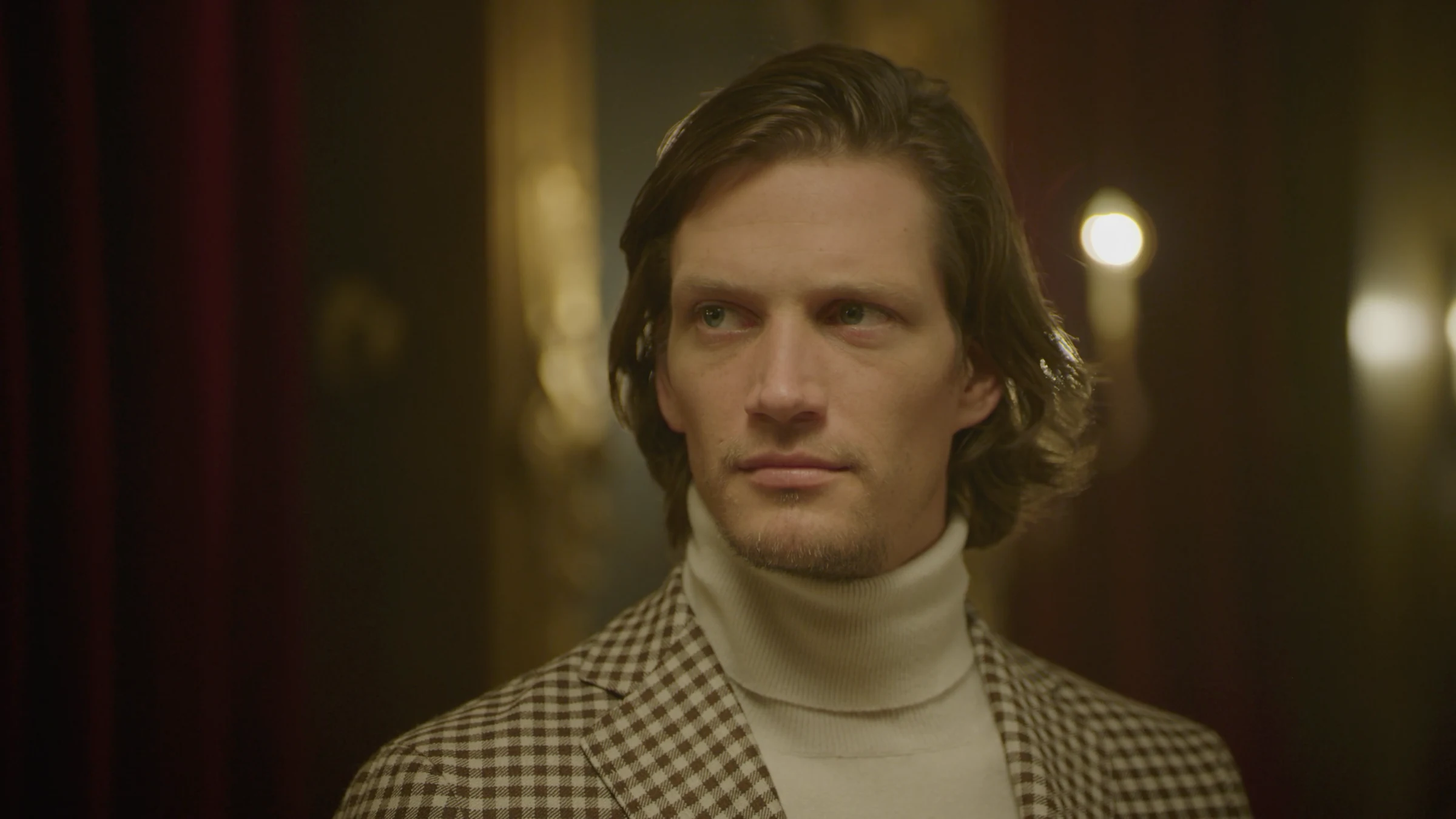 Portrait in a checked jacket and cream turtleneck