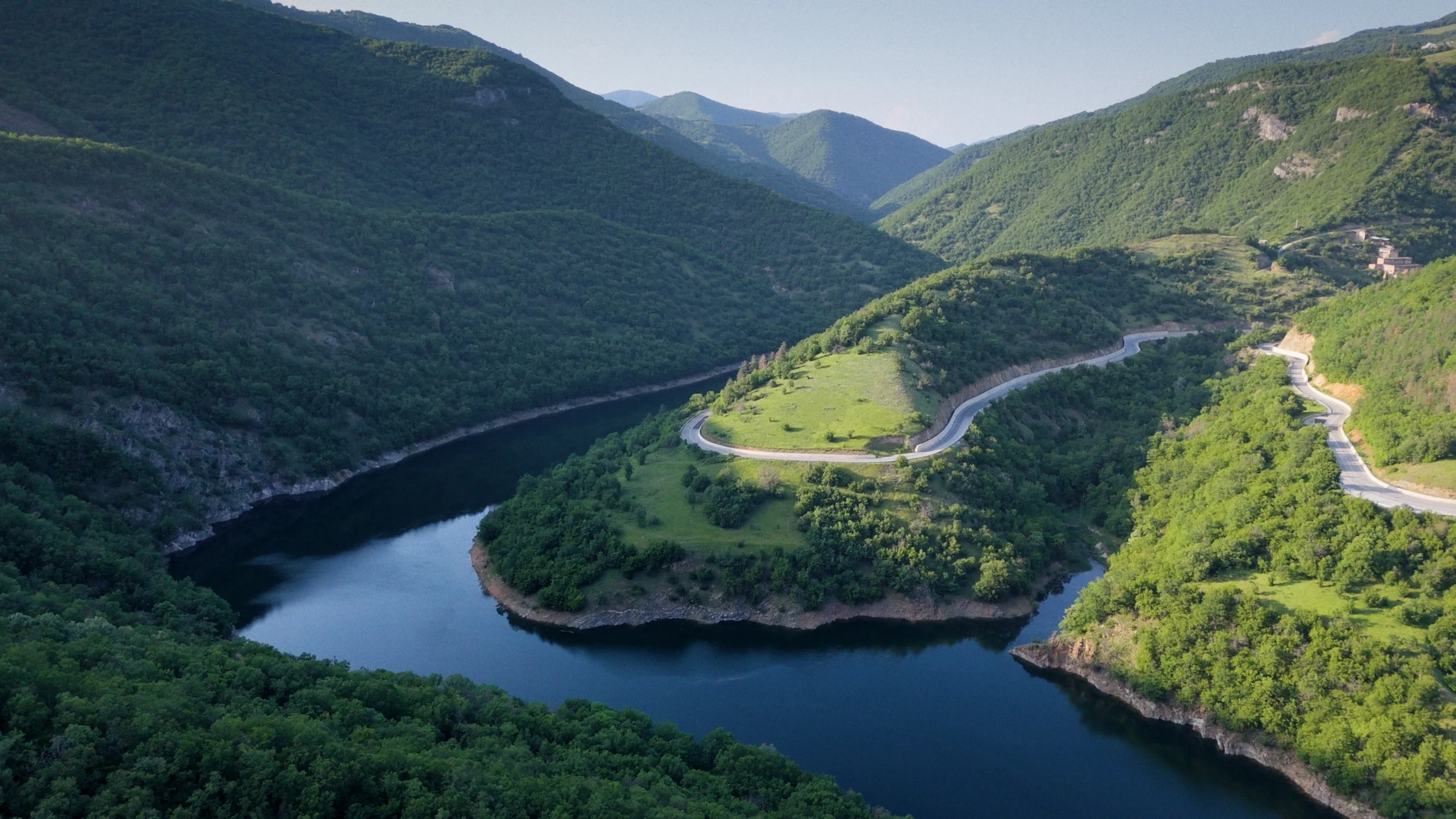 A river meandering between forested mountains
