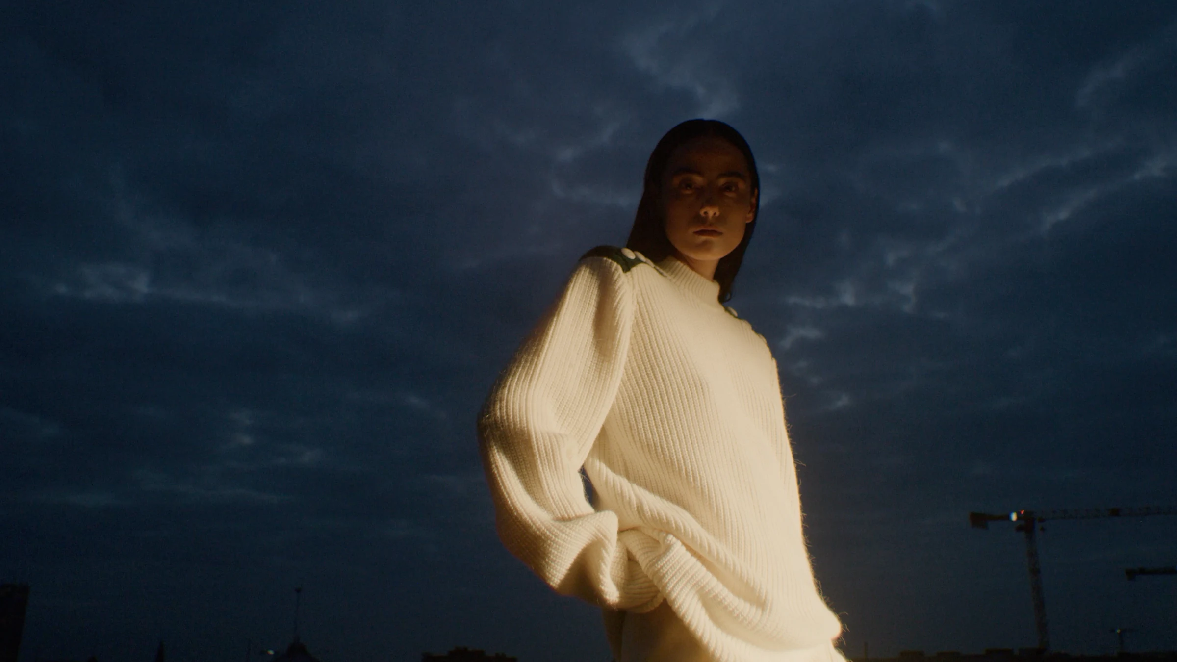 Cream knitwear illuminated against the evening sky