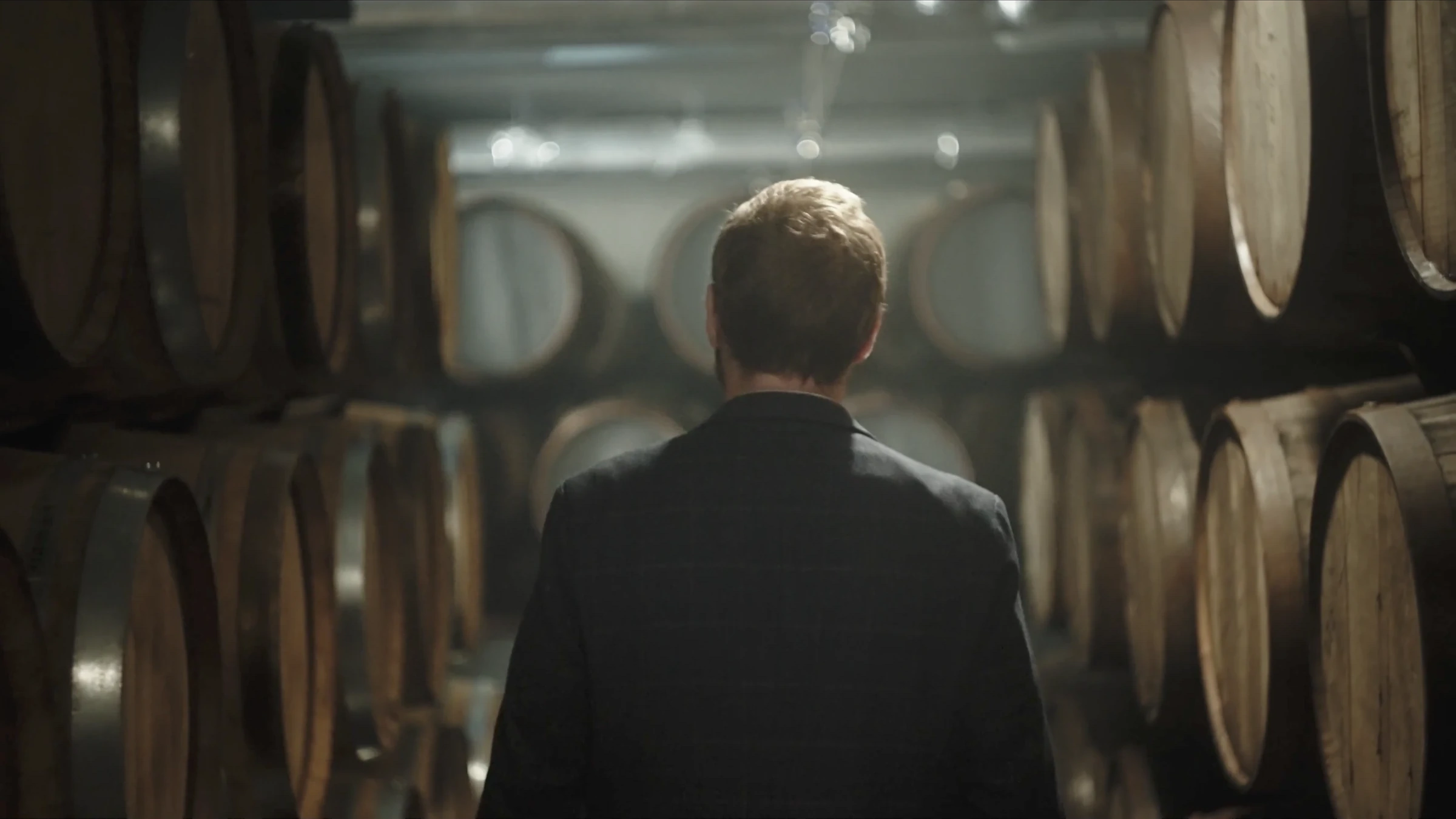 Walking between rows of oak barrels